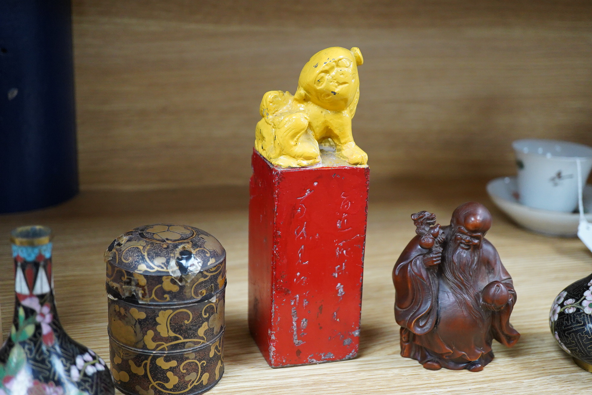A pair of Chinese cloisonné enamel vases, a soapstone seal, an 18th century Japanese lacquer box and a wood figure of Shou Lao, tallest 19cm